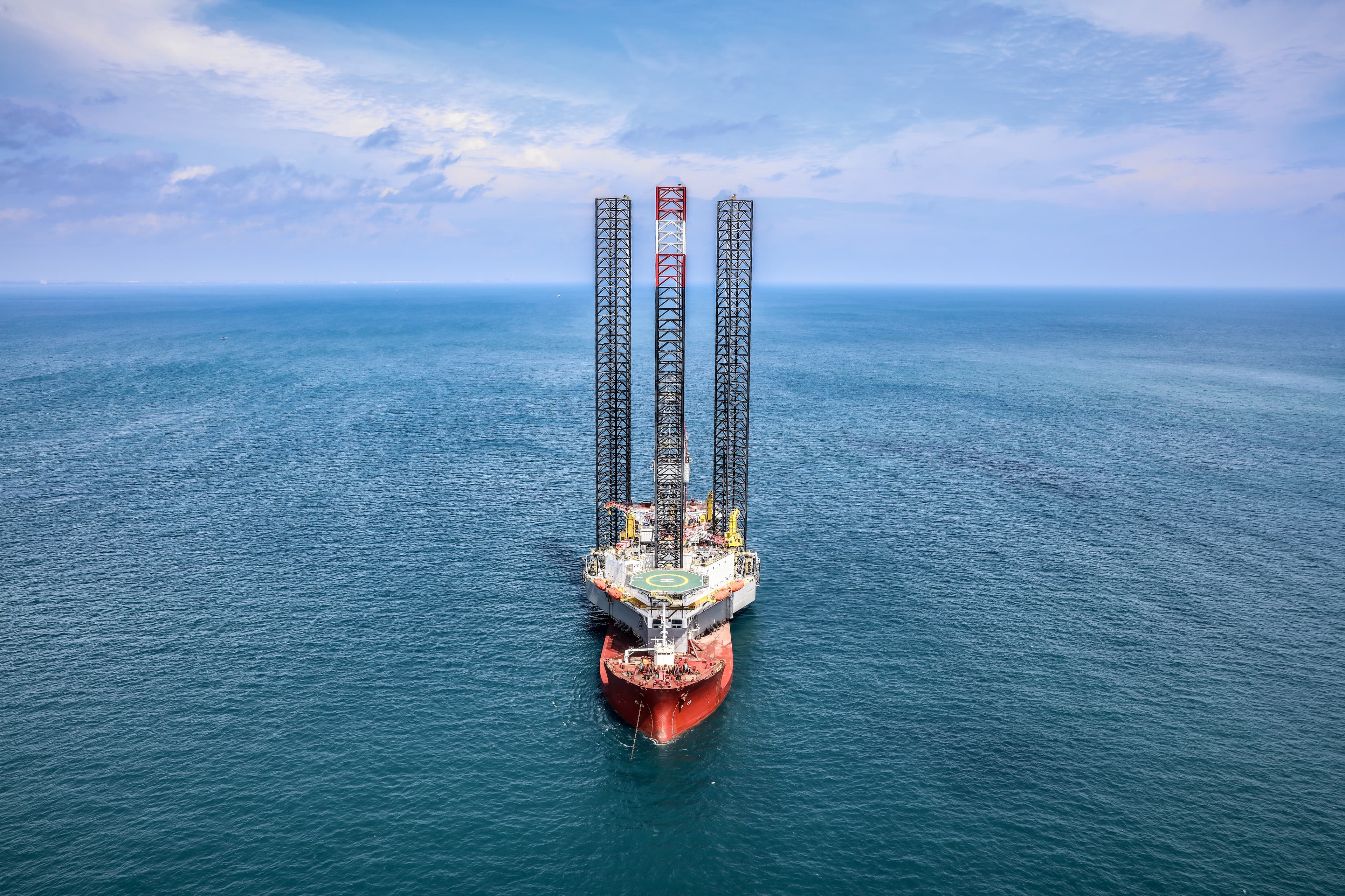 A jack-up rig under tow at sea